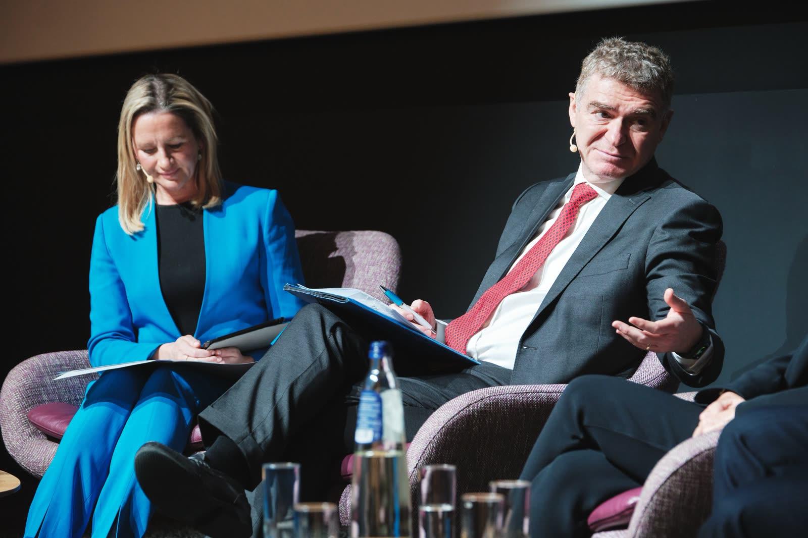 Two panelists in discussion, 2024